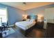 Bedroom features a wood bed frame, a ceiling fan, and a wood floor at 9257 Outlook Rock Trl, Windermere, FL 34786