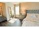 Elegant bedroom features a tufted headboard, wood floors, and a mirrored dresser at 9257 Outlook Rock Trl, Windermere, FL 34786