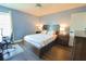 Bedroom features a wood bed frame, a ceiling fan, and a wood floor at 9257 Outlook Rock Trl, Windermere, FL 34786
