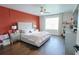 Stylish bedroom features a modern ceiling fan, wood floors, and an accent wall at 9257 Outlook Rock Trl, Windermere, FL 34786