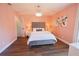 Stylish bedroom featuring a velvet headboard, chandelier, and fresh light-pink paint at 9257 Outlook Rock Trl, Windermere, FL 34786