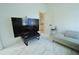 Well-lit bonus room with a large TV, comfortable seating, and minimalist decor at 9257 Outlook Rock Trl, Windermere, FL 34786