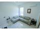 Minimalist bonus room features sleek sectional sofa and bright lighting at 9257 Outlook Rock Trl, Windermere, FL 34786