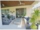 Covered patio shows outdoor seating, a fire table, and ceiling fans, creating a relaxed backyard space at 9257 Outlook Rock Trl, Windermere, FL 34786