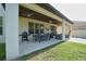 The covered patio features outdoor dining and seating areas, complete with ceiling fans at 9257 Outlook Rock Trl, Windermere, FL 34786