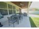 The patio includes an outdoor dining area, seating arrangement, and ceiling fans for comfort and shade at 9257 Outlook Rock Trl, Windermere, FL 34786