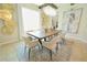 Bright dining room with modern chandelier, decorative wall art, and a large rug at 9257 Outlook Rock Trl, Windermere, FL 34786