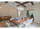 Elegant dining room with statement lighting, wood beam ceiling, and accent wall at 9257 Outlook Rock Trl, Windermere, FL 34786