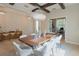 Elegant dining room with statement lighting, wood beam ceiling, and accent wall at 9257 Outlook Rock Trl, Windermere, FL 34786