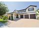 Beautiful two-story home with a three-car garage, landscaped yard, and paver driveway at 9257 Outlook Rock Trl, Windermere, FL 34786