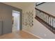 Inviting foyer featuring a staircase with wood railing, decorative mirrors, and neutral tones at 9257 Outlook Rock Trl, Windermere, FL 34786