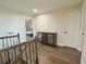 Upstairs hallway with wood flooring and decorative furnishings at 9257 Outlook Rock Trl, Windermere, FL 34786