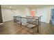 Upstairs hallway with wood flooring and decorative railing at 9257 Outlook Rock Trl, Windermere, FL 34786