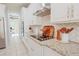 Modern kitchen with stainless steel appliances, granite countertops, white cabinets, and herringbone backsplash at 9257 Outlook Rock Trl, Windermere, FL 34786