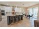 Bright, open kitchen with granite island, stainless steel appliances, pendant lighting, and adjacent breakfast nook at 9257 Outlook Rock Trl, Windermere, FL 34786