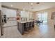 Bright open kitchen with an island, modern pendant lighting, white cabinets, and stainless steel appliances at 9257 Outlook Rock Trl, Windermere, FL 34786