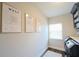 Laundry area with grey cabinets, modern appliances and framed images of laundry symbols at 9257 Outlook Rock Trl, Windermere, FL 34786