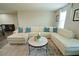 Spacious living room featuring a white sectional sofa, area rug, and natural light at 9257 Outlook Rock Trl, Windermere, FL 34786