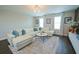 Spacious living room featuring a white sectional sofa, area rug, and natural light at 9257 Outlook Rock Trl, Windermere, FL 34786
