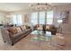 Bright living room featuring stylish sofas, decorative pillows, and elegant chandelier lighting at 9257 Outlook Rock Trl, Windermere, FL 34786