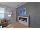 Cozy living area featuring an electric fireplace with decorative mantel and accent wall at 9257 Outlook Rock Trl, Windermere, FL 34786