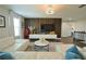 Elegant living room with wood accent wall and recessed lighting at 9257 Outlook Rock Trl, Windermere, FL 34786