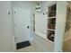 A functional mudroom entryway, complete with a bench, coat hooks, and custom shelving at 9257 Outlook Rock Trl, Windermere, FL 34786