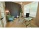 Modern office with a glass desk, decorative wall paneling, and a stylish light fixture at 9257 Outlook Rock Trl, Windermere, FL 34786