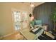Office with an accent wall, french doors, a glass desk, and a stylish light fixture at 9257 Outlook Rock Trl, Windermere, FL 34786