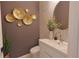 Stylish powder room showcasing modern fixtures, a vessel sink, and decorative gold accents at 9257 Outlook Rock Trl, Windermere, FL 34786