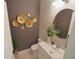 Stylish powder room showcasing modern fixtures, a vessel sink, and decorative gold accents at 9257 Outlook Rock Trl, Windermere, FL 34786