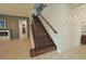 Ornate staircase with wood steps and an iron railing, set against contemporary wall designs at 9257 Outlook Rock Trl, Windermere, FL 34786