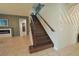 A beautiful staircase is central to this home's design with custom wood and an elegant wrought iron railing at 9257 Outlook Rock Trl, Windermere, FL 34786