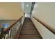 Looking up the wood staircase featuring wrought iron railing detail at 9257 Outlook Rock Trl, Windermere, FL 34786