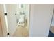 Cozy powder room with tiled floors, toilet and open door at 9257 Outlook Rock Trl, Windermere, FL 34786
