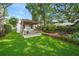 Beautifully landscaped backyard with pool, spa, pergola, outdoor seating, and lush lawn at 1008 Delaney Park Dr, Orlando, FL 32806