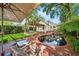 Beautiful backyard with pool, landscaping, outdoor seating, and pergola at 1008 Delaney Park Dr, Orlando, FL 32806