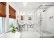 Bright bathroom featuring double sinks, glass enclosed shower, and marble floors at 1008 Delaney Park Dr, Orlando, FL 32806