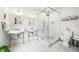 Bright bathroom with double sinks, glass enclosed shower, and a toilet at 1008 Delaney Park Dr, Orlando, FL 32806