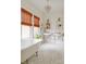 Bright bathroom features a clawfoot tub, dual sinks, a crystal chandelier, and stylish mosaic tile flooring at 1008 Delaney Park Dr, Orlando, FL 32806