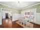 Bright dining room with hardwood floors and detailed trimwork, open to the living room at 1008 Delaney Park Dr, Orlando, FL 32806