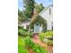 Charming home featuring a vine-covered entrance, a blue front door, and a brick walkway with lush landscaping at 1008 Delaney Park Dr, Orlando, FL 32806