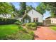 Charming home featuring lush front yard landscaping, a brick walkway, and a quaint blue front door at 1008 Delaney Park Dr, Orlando, FL 32806
