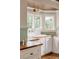 Charming kitchen with butcher block countertops, white cabinetry, and a bay window overlooking lush greenery at 1008 Delaney Park Dr, Orlando, FL 32806