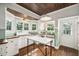 Bright kitchen with a wood ceiling, farmhouse sink, marble island and an abundance of natural light at 1008 Delaney Park Dr, Orlando, FL 32806