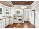 Traditional kitchen with wood ceiling, white appliances, butcher block counters, and plenty of natural light at 1008 Delaney Park Dr, Orlando, FL 32806