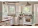 Bright kitchen featuring butcher block countertops, white cabinets, and vintage-style range at 1008 Delaney Park Dr, Orlando, FL 32806
