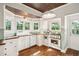 Charming kitchen with butcher block countertops, white cabinets, and vintage-style appliances at 1008 Delaney Park Dr, Orlando, FL 32806