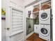 Convenient laundry area with stacked washer/dryer and practical storage solutions at 1008 Delaney Park Dr, Orlando, FL 32806