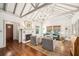 Bright living room featuring a fireplace, hardwood floors, vaulted ceiling, and cozy seating at 1008 Delaney Park Dr, Orlando, FL 32806